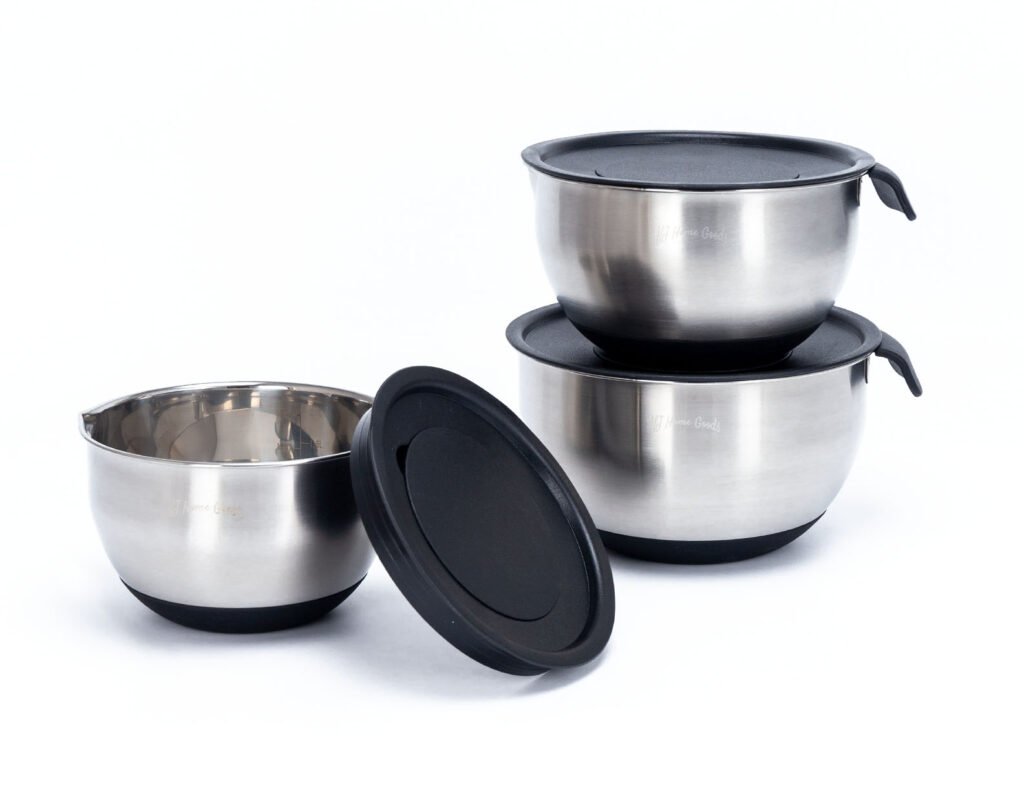 Three stainless steel mixing bowls with snug-fitting black lids in graduated sizes