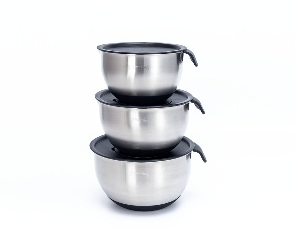 Stainless steel mixing bowl set with black lids stacked together for compact storage