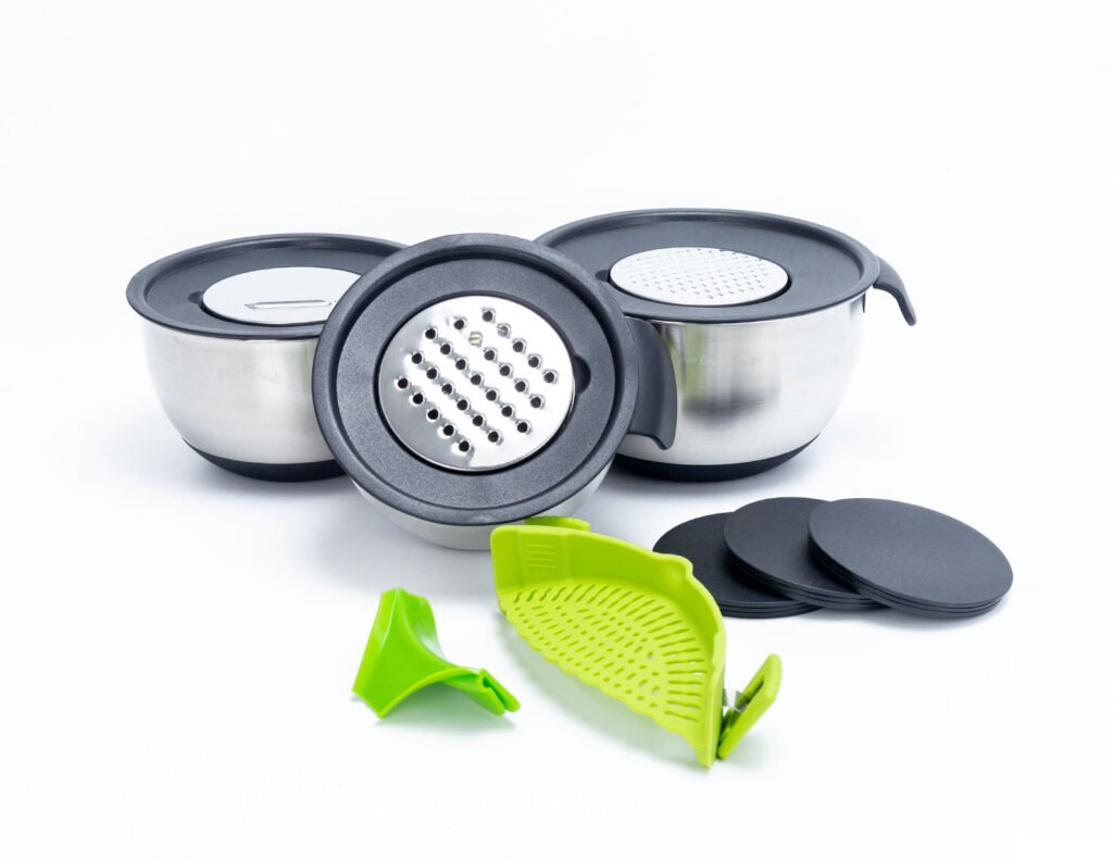 Three stainless steel mixing bowls nested vertically with black lids for space-saving storage