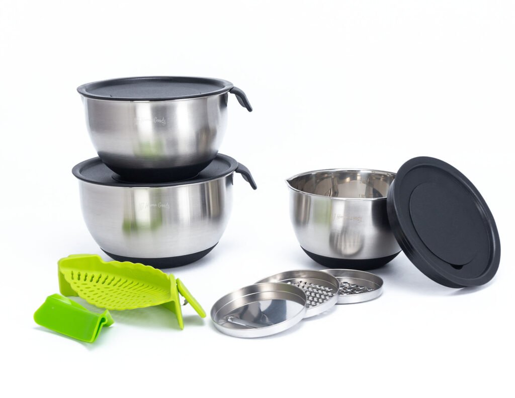 Stainless steel mixing bowl set with black lids stacked together for compact storage